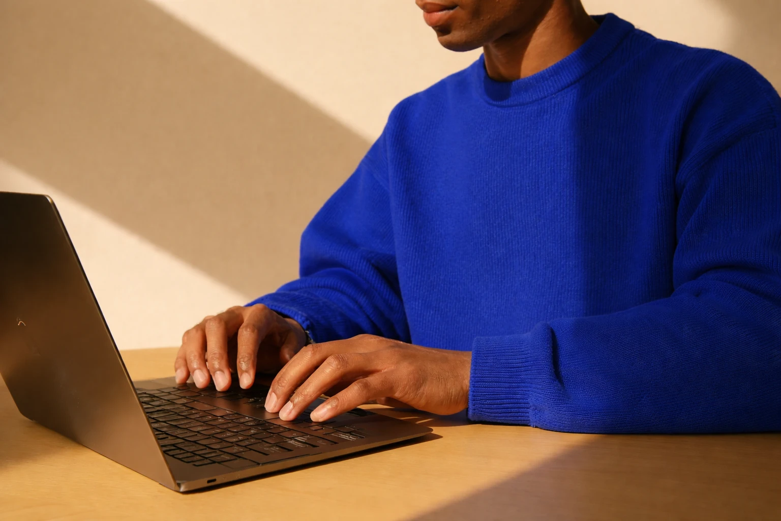 A writer drafting a post on a laptop